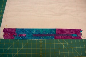 Press open your strips. Then cut another strip from the bottom of panel 2 and layer it face down on top of the previous strip you sewed. Sew the next strip in place.