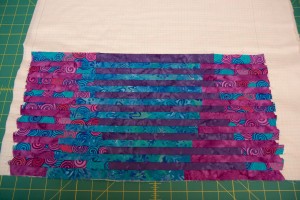 Continue alternating between panel 1 and panel 2 strips until you cover the grid. You may have a couple extra strips left over. (To avoid leftover strips, your grid fabric should be at least .5-inch taller than your fabric tubes.)