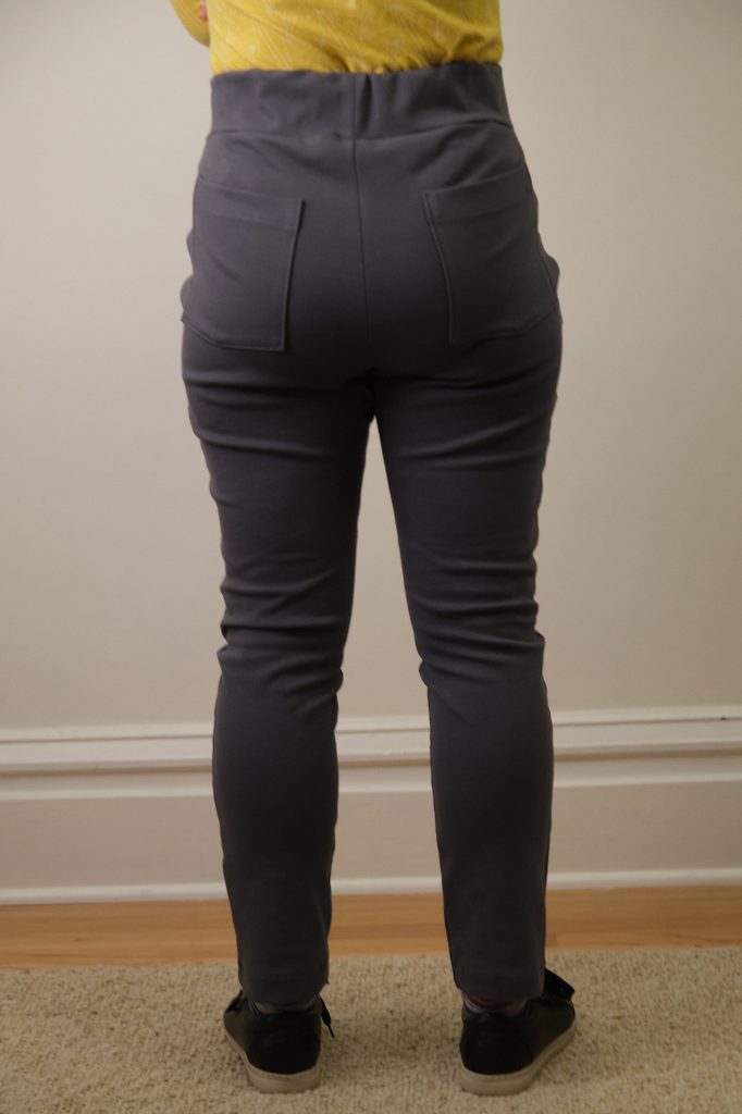 Women's charcoal grey active high rise capri leggings workout leggings. -  Flattening elasticized waistband with interior pocket and back zipper pocket  - Figure sculpting skinny leg design - Exterior side pocket along